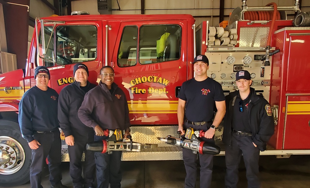 Group photo of firefighters with equipment and fire truck